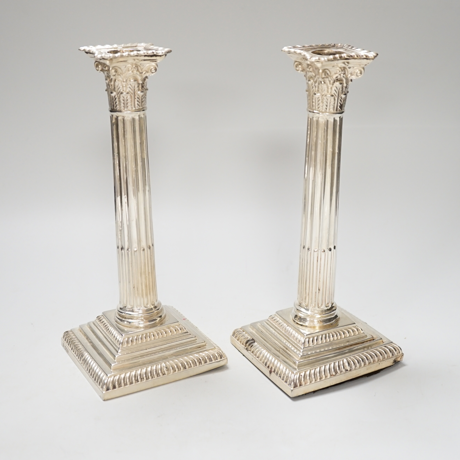 A pair of late Victorian silver Corinthian column candlesticks, with loaded bases, Sheffield 1899, 22.5cm